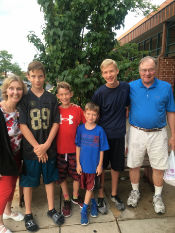 Dr. Gerry Haller and family posing for a picture outside.